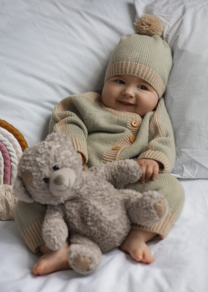 top view cute baby with stuffed animal scaled 1